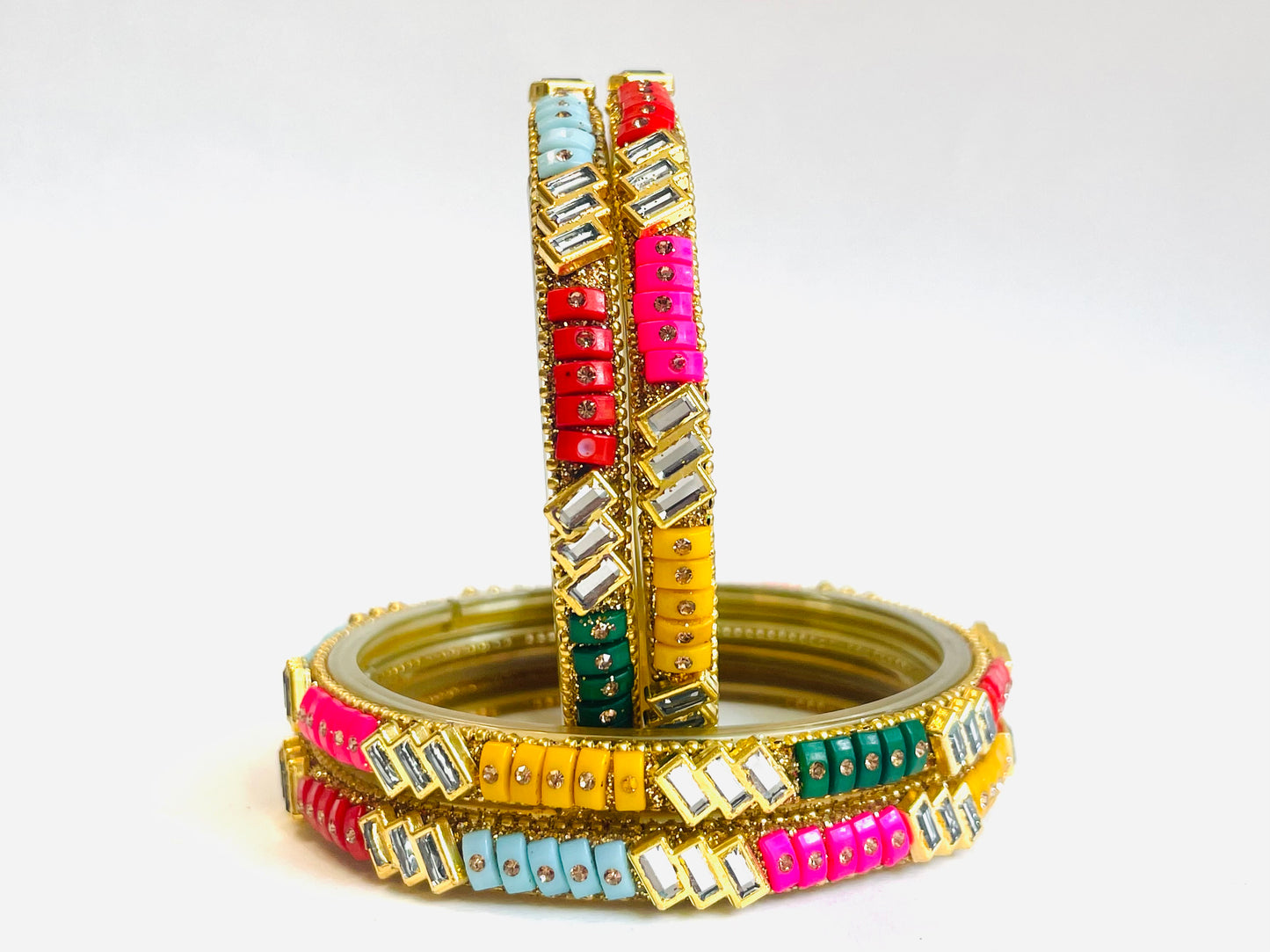 Beautiful set of four multi-colored bangles with modern crystal design.
